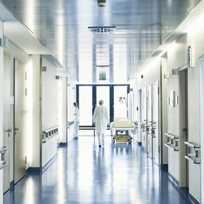 Hospital with corridor bed doctor and nurse with motion blur from behind